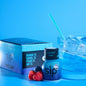 Blue Razz energy drink with packaging, berries, and a glass of ice on a blue background
