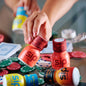 Hand holding a Sip Elixirs bottle with poker chips and cards in the background